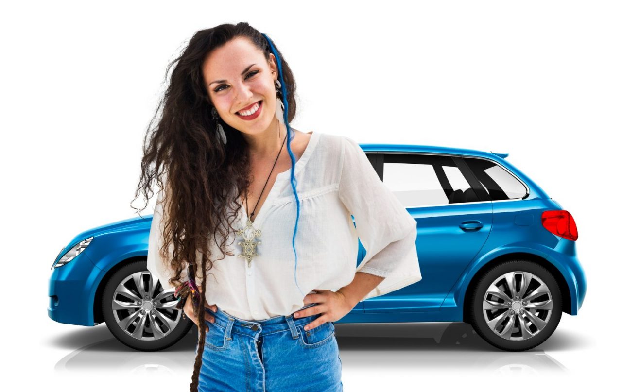Woman standing in front of a blue car, smiling.