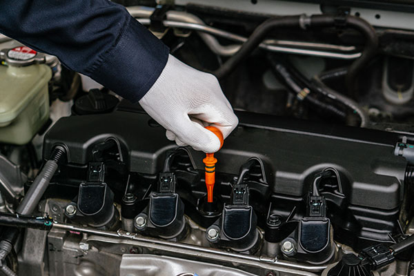 Mechanic performing car maintenance.