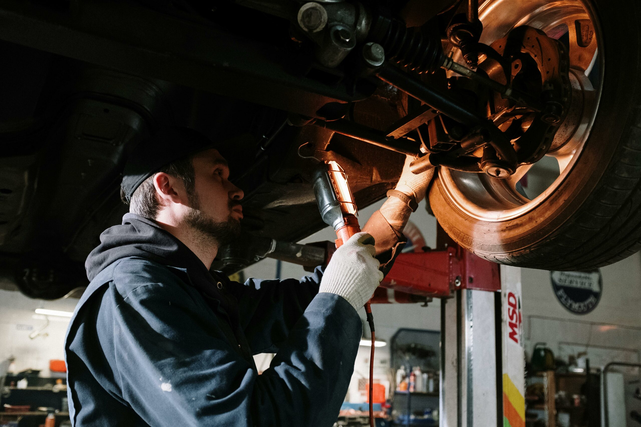 Mechanic inspecting finished work on a vehicle.