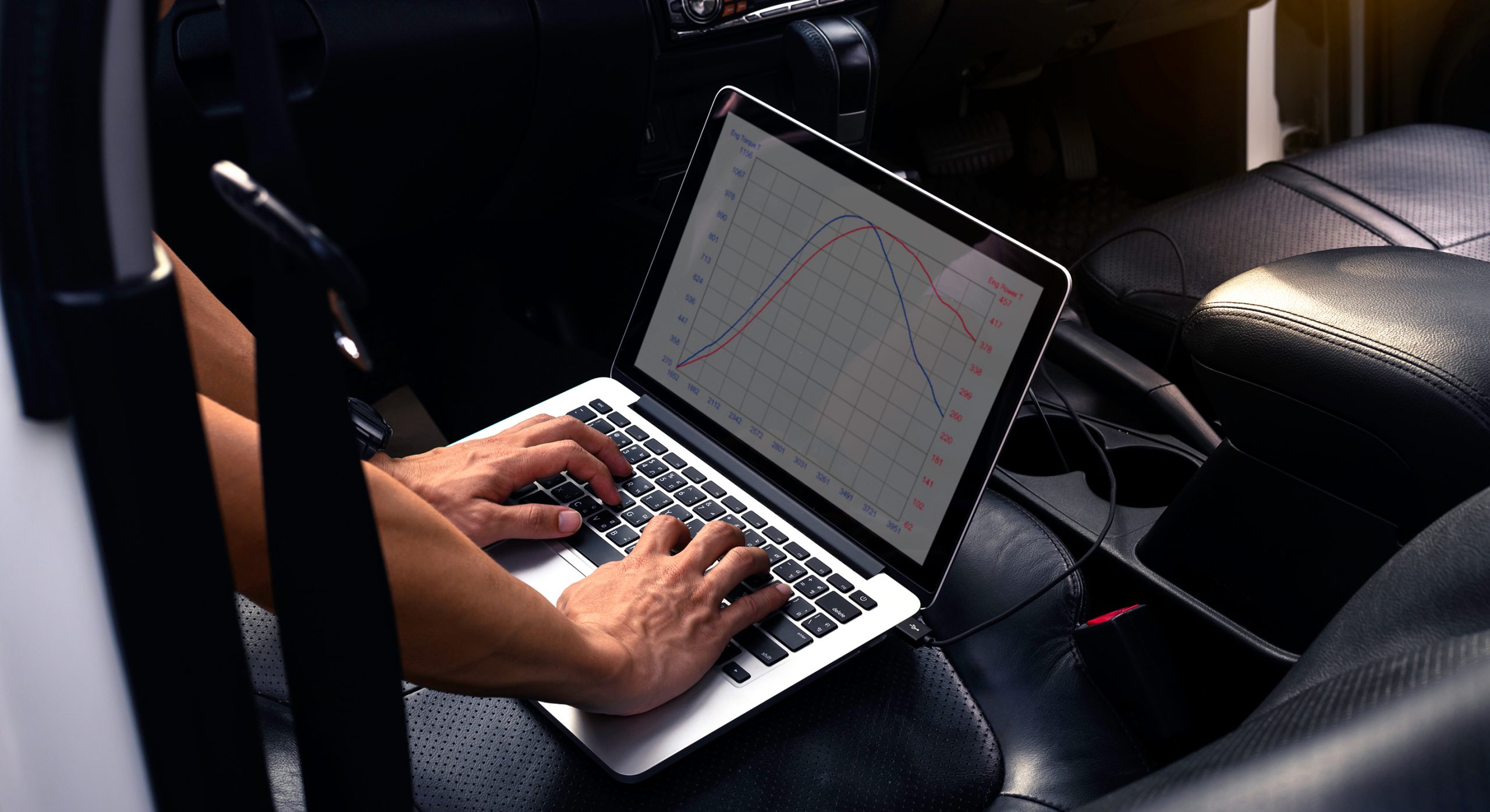 Technician using diagnostic equipment on a vehicle.